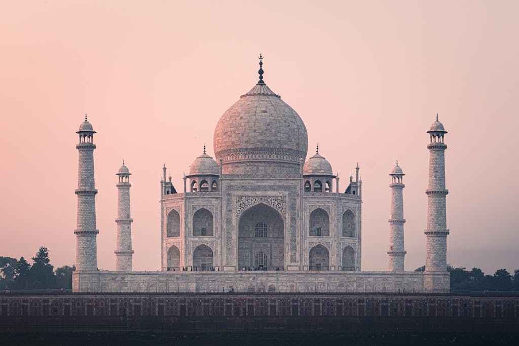 Beautiful view of the Taj Mahal at sunrise, showcasing its stunning architecture and historical significance.