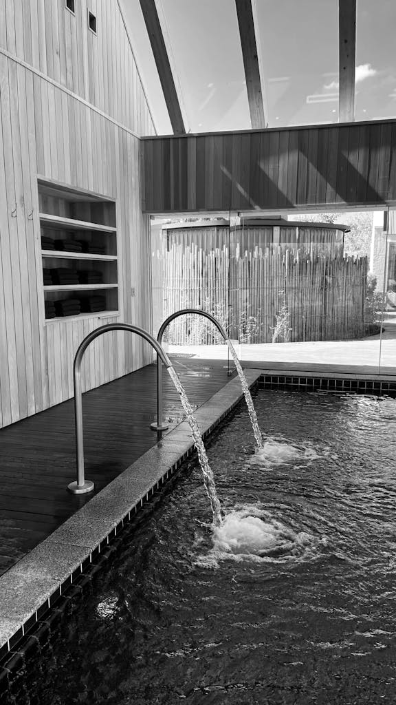 Black and white image of an indoor spa pool featuring relaxing water jets for a tranquil experience.